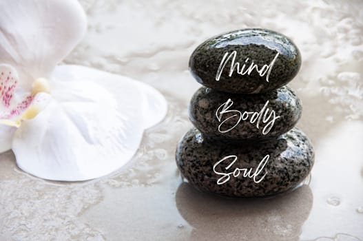 Mind, Body and Soul words engraved on zen stones with space for text. Copy space and zen concept.