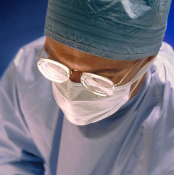 A surgeon in a operation room in a hospital.