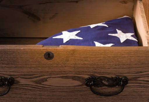 An American Flag of a deceaced veteran lays in a dresser drawer.