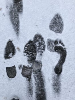 footprints of human feet on white snow