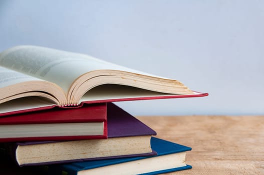 Books on wooden table with customizable space for text or ideas. Copy space.