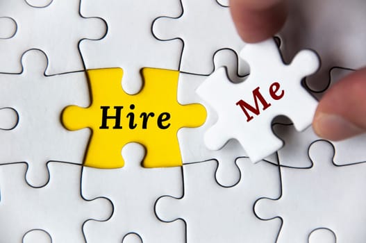 Hire me text on missing jigsaw puzzle. Employment and hiring concept.