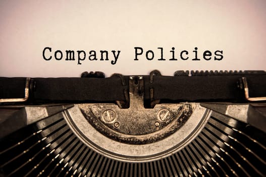 Company policies text typed on an old vintage typewriter.