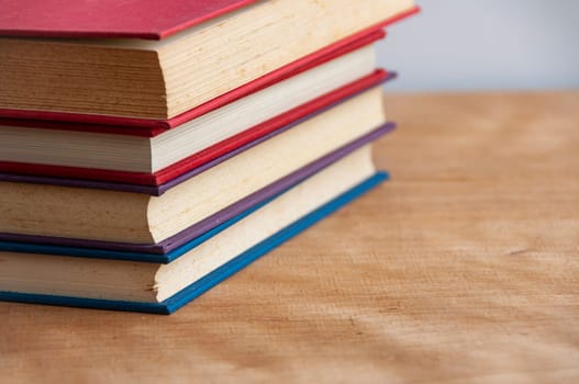 Books on wooden table with customizable space for text or ideas. Copy space.