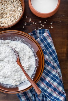 Oatmeal bowl. Cooked oatmeal served with fresh milk. Healthy breakfast food, diet. Top view.