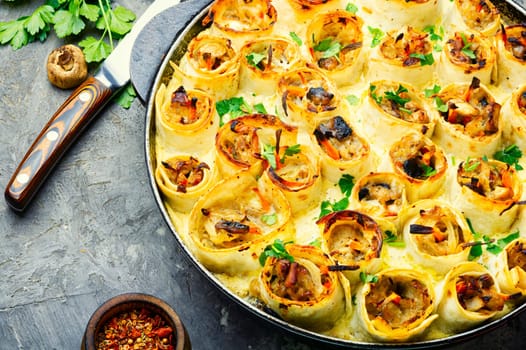Vegetables baked with cheese in pita bread on wooden table.