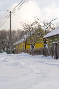 Snowy russian village, village with snowy road and houses.