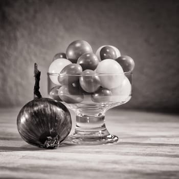 Still life with onion and tomato in jar