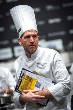 Lyon, Rhone Alpes Auvergne, France  january 22, 2023 : BOCUSE D'OR Lyon Eurexpo Sirha event 2023. The famous french chef Alexandre Mazzia portrait with sirha document. He is the jury member for the Bocuse d'or competition of the elite cookers in the world. Alexandre Mazzia is the chef of the AM redstaurant in Marseille.