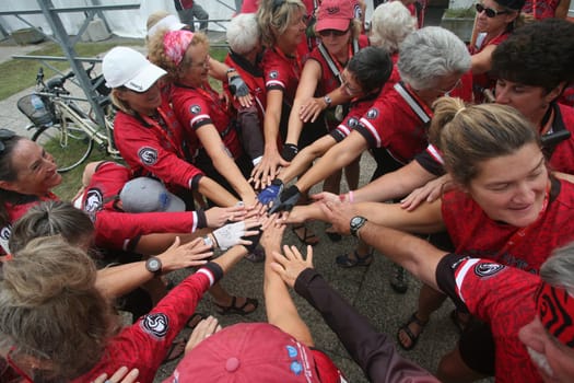 Dragon boat racers unite hands before a race in Burlington, Vermont.