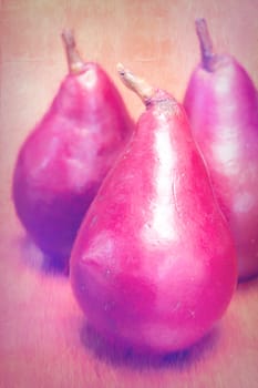 Three pears on a table.