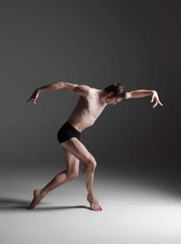 The young attractive modern ballet dancer over white background