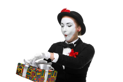 Mime as playful, joyful and excited woman with gift standing isolated on white background.