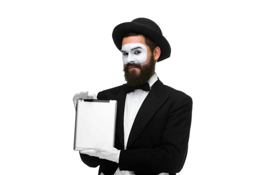 Man with a face mime working on a laptop isolated on a white background. concept of presentation in business