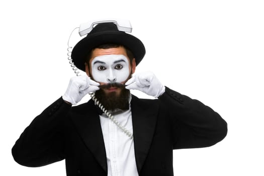 man in the image mime holding a handset isolated on white background. The concept -  I'm always in touch