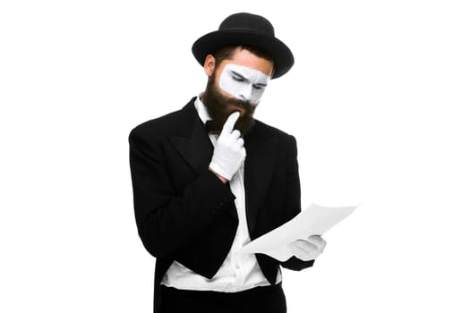 pensive mime as a businessman reading of the list of paper. isolated on white background