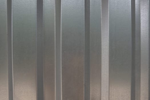 aluminum chrome metal profiled sheet with vertical stripes. metallic gray.