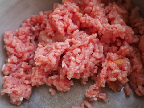 Minced meat in a metal saucepan. Delicious fresh ground meat for making cutlets, steaks, hamburgers, meatballs