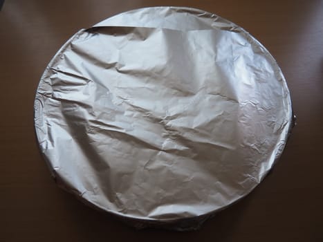 Texture of crumpled aluminum foil for baking. Food foil on a baking sheet before placing in the oven.