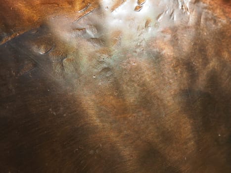 Metal bronze textured plate. Bronze or copper polished surface with dents, scratches and indentations. Metal texture.