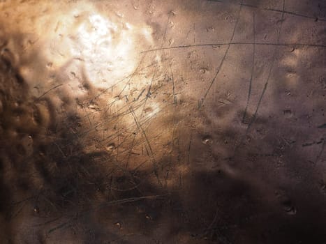 Metal bronze textured plate. Bronze or copper polished surface with dents, scratches and indentations. Metal texture.
