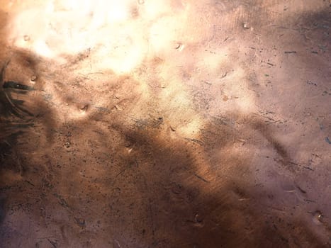 Metal bronze textured plate. Bronze or copper polished surface with dents, scratches and indentations. Metal texture.