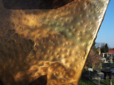 Metal bronze textured plate. Bronze or copper polished surface with dents, scratches and indentations. Metal texture.
