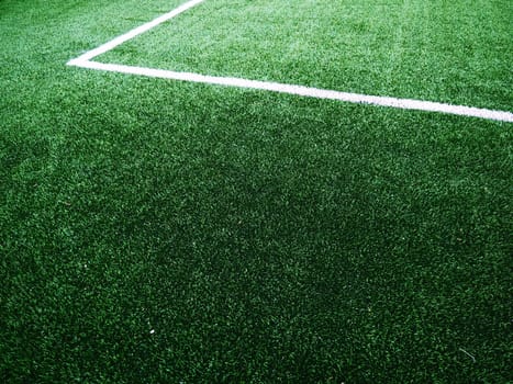The marking of the football field on the green grass. White lines no more than 12 cm or 5 inches wide. Football field area