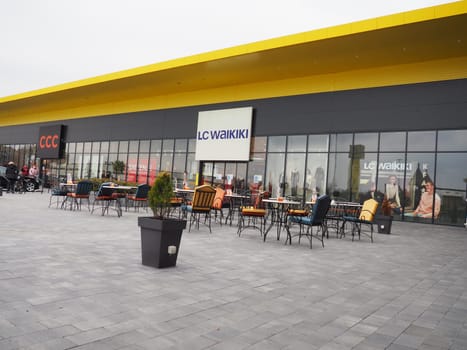Sremska Mitrovica, Serbia, February 27, 2021 Shopping center, clothing store LC WAIKIKI. Sliding doors. Cafe with metal chairs and tables.