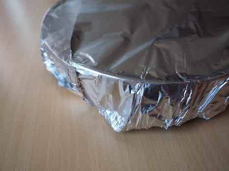 Texture of crumpled aluminum foil for baking. Food foil on a baking sheet before placing in the oven.
