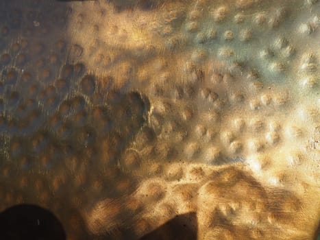 Metal bronze textured plate. Bronze or copper polished surface with dents, scratches and indentations. Metal texture.
