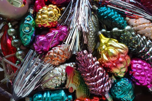 New Year and Christmas tree decorations, glass balls in the form of cones and baskets. Cones and pendants made of shiny tinsel. Festive background postcard layout blank. Lots of Christmas decorations