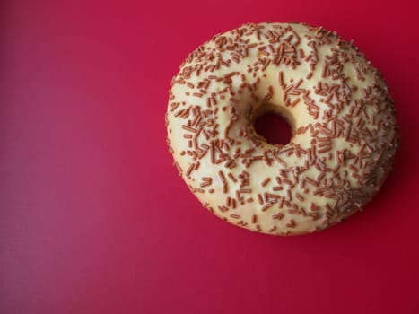 A doughnut or donut. A type of leavened fried dough. Sweet snack. Delicious pie with light icing on gray background.