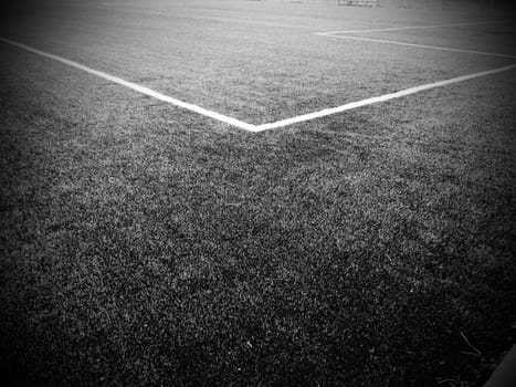 The marking of the football field. White lines no more than 12 cm or 5 inches wide. Football field area. Black and white monochrome photography.