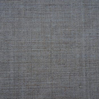 Fabric texture background. Gray fabric with weave. Natural slightly wrinkled look of the material. Uniform copy space background. Cotton, canvas or woolen thin fabric laid evenly on the surface