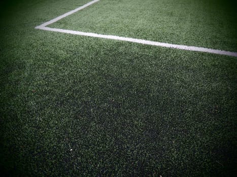 The marking of the football field on the green grass. White lines no more than 12 cm or 5 inches wide. Football field area