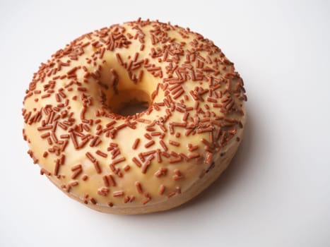 A doughnut or donut. A type of leavened fried dough. Sweet snack that can be homemade or purchased in bakeries, supermarkets, food stalls. Delicious pie with light icing on a white background.