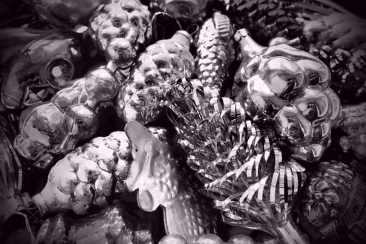 New Year and Christmas tree decorations, glass balls in the form of cones and baskets. Cones and pendants shiny tinsel. Festive background. Lots of Christmas decorations. Black and white monochrome.