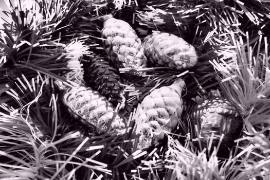 New Year and Christmas tree decorations, glass balls in the form of cones and baskets. Cones and pendants shiny tinsel. Festive background. Lots of Christmas decorations. Black and white monochrome.