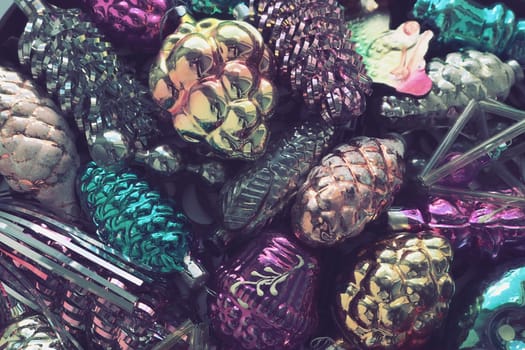 New Year and Christmas tree decorations, glass balls in the form of cones and baskets. Cones and pendants made of shiny tinsel. Festive background. Lots of Christmas decorations. Retro vintage style