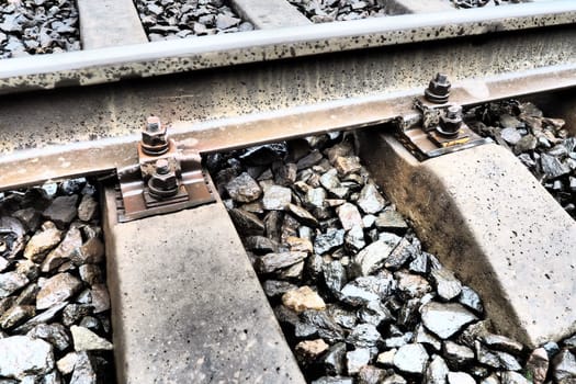 Railways. Metal steel rails and wooden sleepers. Rivets and fasteners on the railroad. Stony backfill of railway tracks. Station Nyrki, Karelia