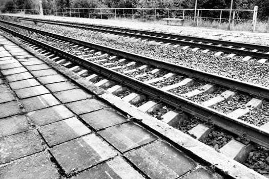 Railways. Metal steel rails and wooden sleepers. Rivets and fasteners on the railroad. Stony backfill of railway tracks. Station Nyrki, Karelia