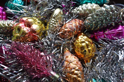 New Year and Christmas decorations, tinsel, boa, Christmas decorations. Multi-colored balls in the form of cones and baskets. Festive interior decoration. New Year or Christmas composition.