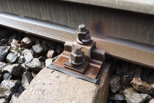 Railways. Metal steel rails and wooden sleepers. Rivets and fasteners on the railroad. Stony backfill of railway tracks. Station Nyrki, Karelia
