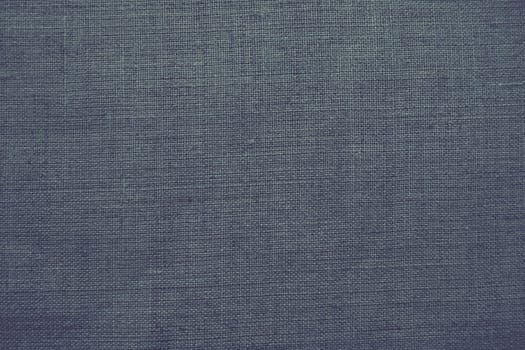 Fabric texture background. Gray fabric with weave. Natural slightly wrinkled look of the material. Uniform copy space background. Cotton, canvas or woolen thin fabric laid evenly on the surface