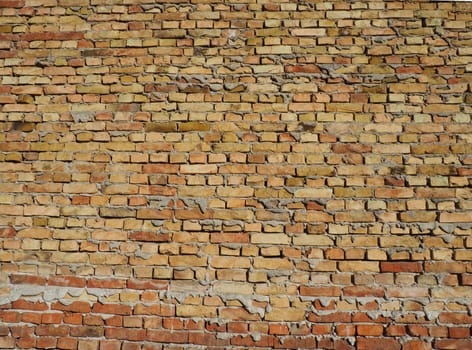 Brick wall of an old building. Cement between rows of bricks.