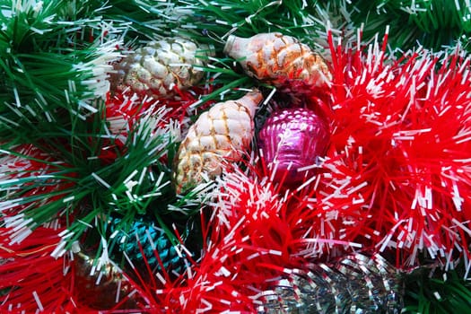 New Year and Christmas decorations, tinsel, boa, Christmas decorations. Multi-colored balls in the form of cones and baskets. Festive interior decoration. New Year or Christmas composition.