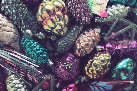 New Year and Christmas tree decorations, glass balls in the form of cones and baskets. Cones and pendants made of shiny tinsel. Festive background. Lots of Christmas decorations. Retro vintage style