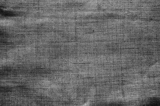 Fabric texture background. Gray fabric with weave. Natural slightly wrinkled look of the material. Uniform copy space background. Cotton, canvas or woolen thin fabric laid evenly on the surface