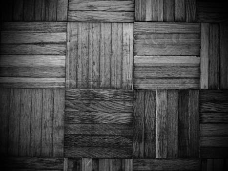 Scratched parquet flooring in the room. Scratches, chips and dents on the floor. Parquet in need of repair. Black and white monochrome image.